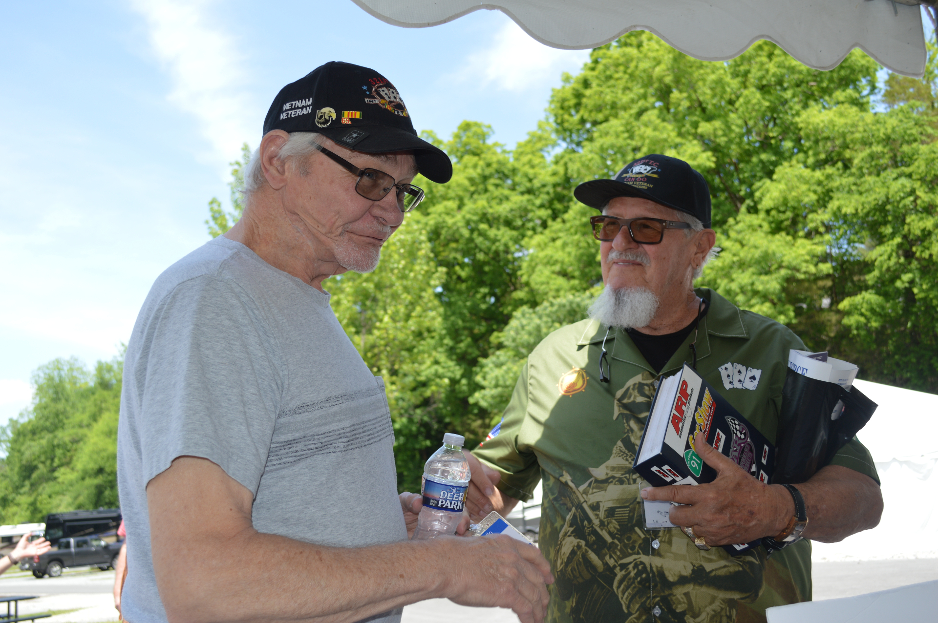 Two Vietnam veterans chatting under the reunion tent