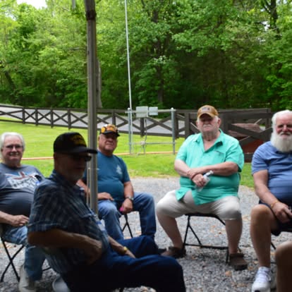 Veterans relaxing and sharing stories outdoors